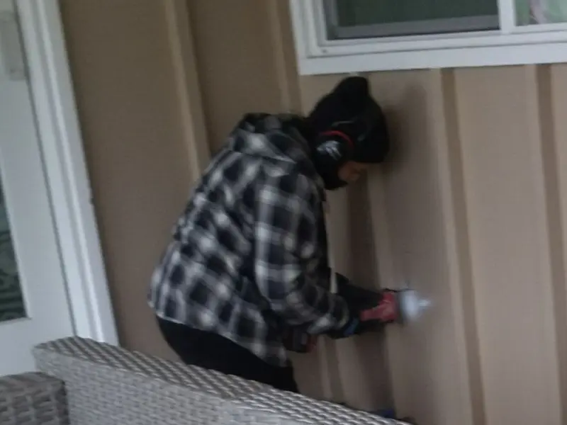 Professional electrician installing an exterior outlet in Douglas
